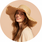 Circular portrait of influencer Belen Hostalet smiling, wearing a BELVIE straw hat, against a soft peach background.